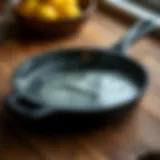 Thoroughly cleaned cast iron skillet on a wooden surface