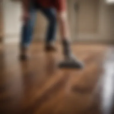 A person applying cleaner to a hardwood surface