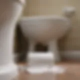 Close-up of a clogged toilet with paper towels